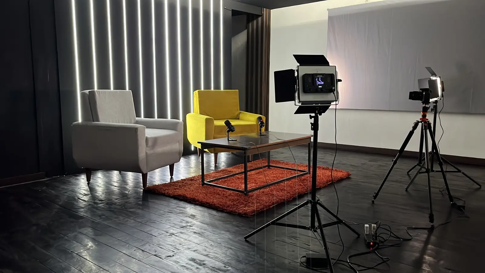Set de podcast con luces LED verticales y sillones